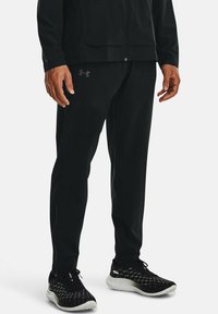 Under Armour - OUTRUN THE STORM - Tracksuit bottoms - black Thumbnail Image 1