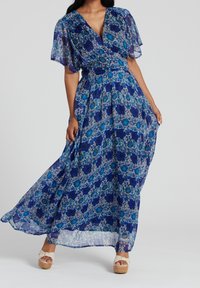Maxi dress in blue floral print with a V-neck, flutter sleeves, and a cinched waist; made of lightweight, flowing fabric.