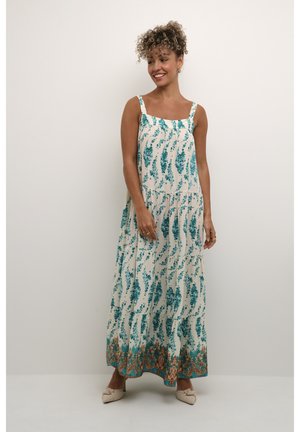 Maxikleid in Creme mit taubenblauen Blumenmuster, quadratischem Ausschnitt und dünnen Trägern. Der Saum ist mit einem kunstvollen braunen und taubenblauen Muster versehen. Weicher, fließender Stoff.
