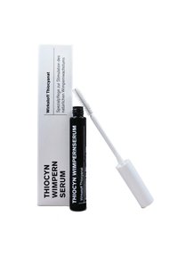 Thiocyn Wimpern Serum in a black tube with a white wand, accompanied by a white box featuring black text. Text describes product purpose.