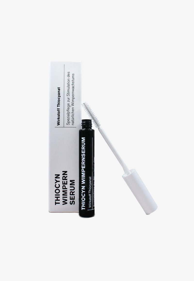 Thiocyn Wimpern Serum in a black tube with a white wand, accompanied by a white box featuring black text. Text describes product purpose.