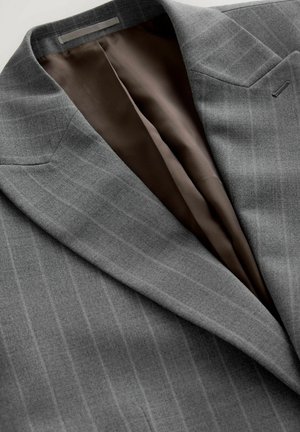 Gray suit jacket with fine vertical stripes, featuring a brown satin lining. Notable details include sharp lapels and a pocket.