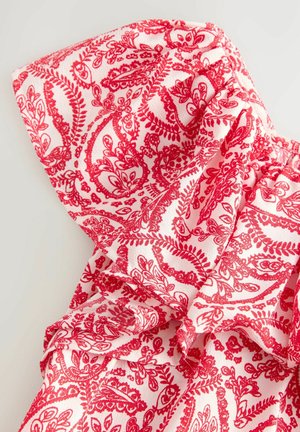 Tessuto rosso a motivo paisley su sfondo bianco, con una texture morbida e bordi arricciati per un tocco di dettaglio in più.