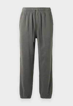 Pantaloni da jogging grigi realizzati in tessuto morbido, con vita elastica e cordino, tasche laterali e polsini elasticizzati alla caviglia.