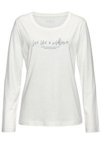 T-shirt à manches longues blanc en tissu doux, avec un col rond et une citation inspirante imprimée en bleu marine.