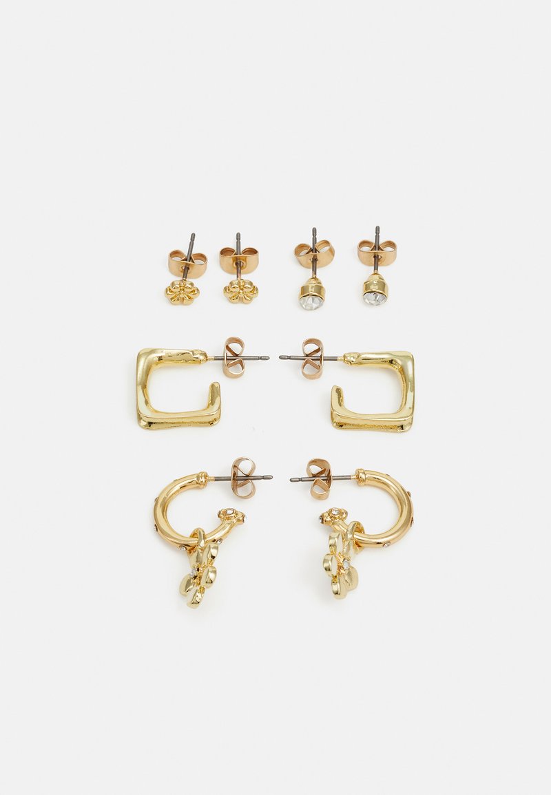 Set of gold-tone earrings including two pairs of studs, a chunky square design, and a floral accent hoop, showcasing various shapes and finishes.