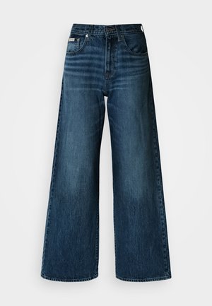 Jeans à jambes larges en denim bleu foncé. Caractérisés par une taille haute, des poches latérales et un design classique à cinq poches. Texture lisse avec un léger effet délavé.