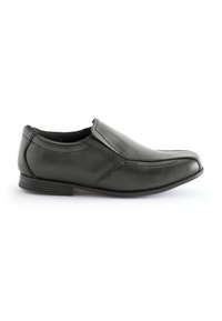 Chaussure noire en cuir à enfiler avec des panneaux élastiques sur les côtés, présentant des coutures détaillées et un talon bas empilé. Texture lisse et bout rond.