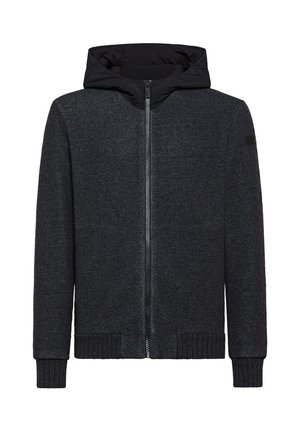 Felpa con zip nera realizzata in un tessuto strutturato, con polsini e orlo a costine. Presenta una fodera interna nera a contrasto e un accento con logo sulla manica.