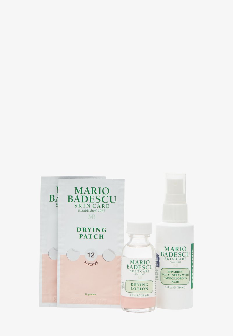 Two drying patch sachets, one drying lotion bottle, and one repairing facial spray bottle from Mario Badescu skincare on white background.
