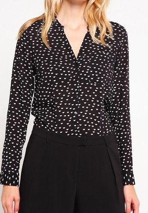Zwarte blouse met lange mouwen en knoopsluiting aan de voorkant, met een wit driehoekig patroon en een zachte, lichte stof. Getailleerde pasvorm.