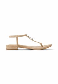 Sandali piatti in suede beige con design a T, cinturino alla caviglia regolabile e suola minimalista. Nessun accento o dettaglio hardware in evidenza.