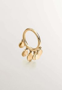 Anillo de oro con un acabado pulido, que presenta cinco encantos ovalados colgantes. Textura lisa y forma circular, diseñado con acentos colgantes.