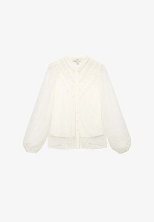 Witte kantblouse met een knoopsluiting aan de voorkant, lange ballonmouwen en gestructureerde details rond de halslijn en het lijfje. Semi-doorzichtige stof.