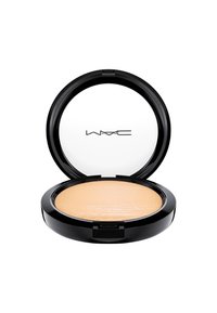 Poudre compacte dans un boîtier rond noir, avec un couvercle transparent. Présente une poudre lisse, couleur beige clair, avec une surface texturée et le logo de la marque.