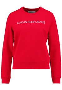 Sudadera roja de mezcla de algodón, con mangas largas y puños acanalados. En la parte frontal tiene texto blanco que dice "CALVIN KLEIN JEANS".