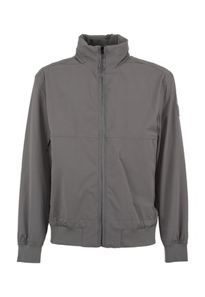 Giacca leggera grigia con colletto alto, cerniera frontale, polsini ed elastico in vita. Presenta due tasche laterali e una texture liscia.