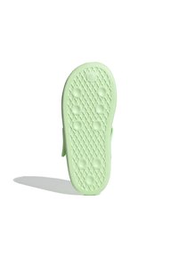 Ljust grön skosula med ett texturerat diamantmönster, cirkulära punkter för grepp och en rundad form; ingen synlig branding eller detaljer.