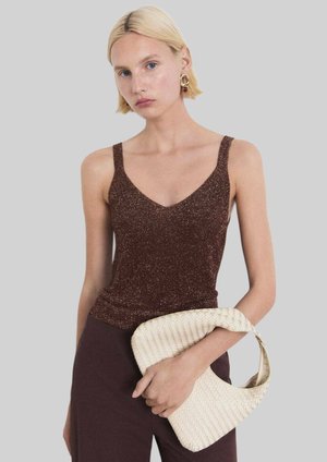 Brown glittery tank top with thin straps and a V-neckline, paired with a woven cream handbag. Smooth texture, fitted design.