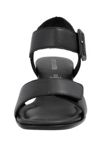 Black leather sandal with two wide straps, a buckle detail, and a flat sole. The insole is padded for comfort. Minimalist design.
