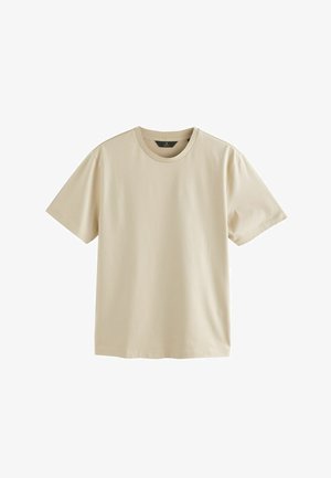 Bež majica iz bombaža s kratkimi rokavi, okroglim izrezom in sproščenim krojem. Gladka tekstura brez vidnih vzorcev ali poudarkov.