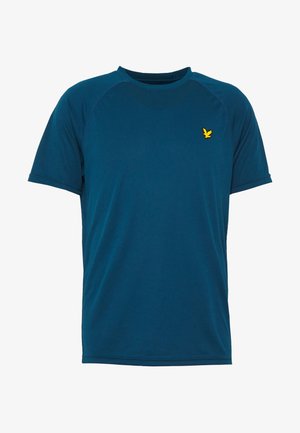 Sininen lyhythihainen T-paita, joka on valmistettu kevyestä, teksturoidusta kankaasta. Siinä on ribberöity pyöreä kaula-aukko ja pieni keltainen logo vasemman rinnan yläpuolella.