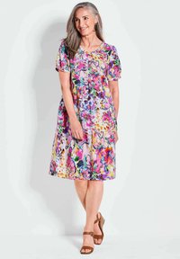 Blumenmuster Baumwollkleid mit kurzen Puffärmeln, rundem Ausschnitt und mehrfarbigem Muster in Pink-, Lila- und Grüntönen. Knielange.
