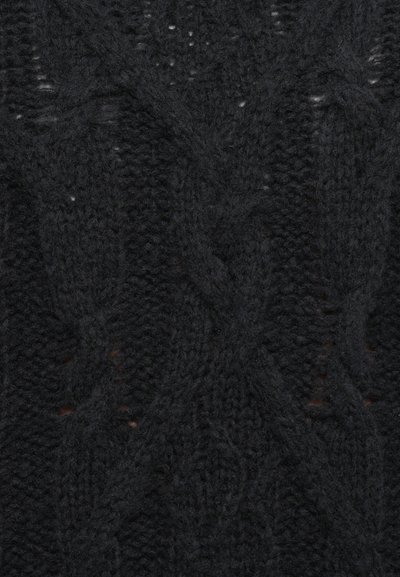 Black knitted sweater fabric featuring a textured cable pattern and uneven stitches, with slight variations in thickness.
