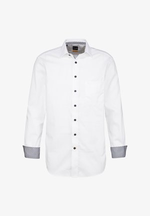 Camicia bianca con maniche lunghe, polsini a motivo a contrasto e taschino sul petto. Bottoni neri accentuano la patta anteriore.