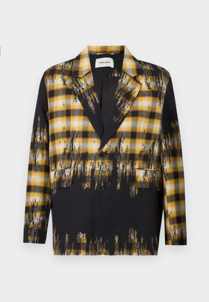 Black and yellow plaid blazer with a brushstroke pattern. Features a notched collar, two front pockets, and a single button closure.