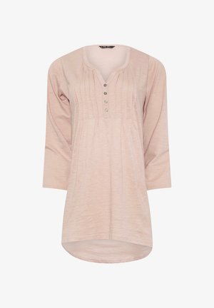 Light pink long-sleeve tunic with a V-neck, pleated front, and six-button placket. Soft fabric with a rounded hem and relaxed fit.