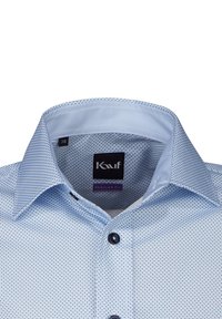 Camicia a fantasia blu chiaro con vestibilità regolare. Presenta un colletto strutturato, bottoni neri e un'etichetta con la dicitura "Vestibilità Regolare."