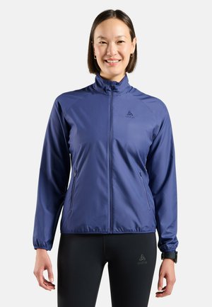Navy zip-up jacket made from lightweight material, featuring a high collar, elastic cuffs, and two zippered side pockets.