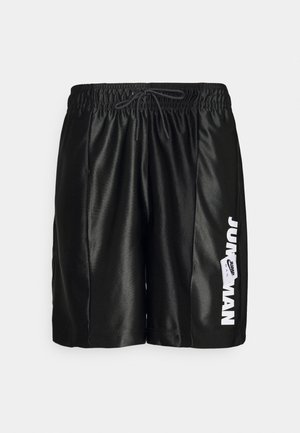 Shorts de sport noirs avec taille élastique et cordon de serrage, arborant le texte blanc « Jump Man » et le logo sur la jambe droite.