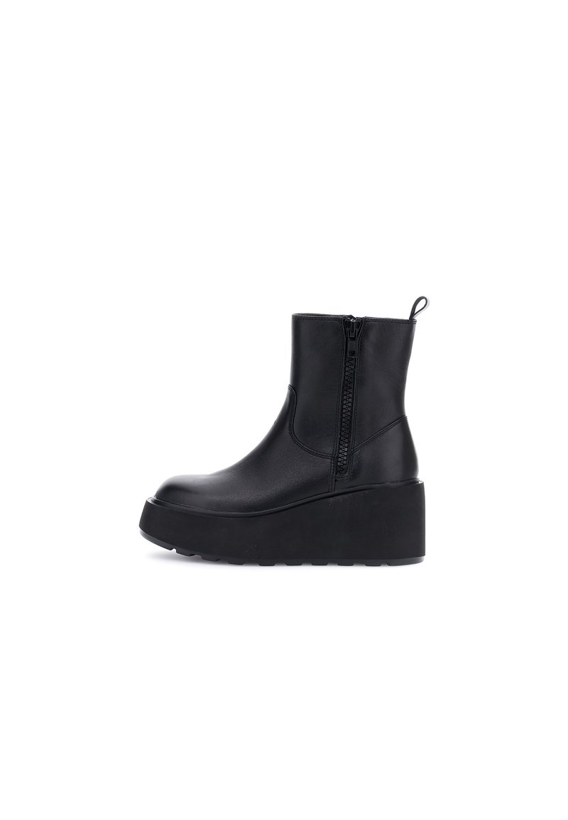 Botas de cuero negro hasta el tobillo con cremallera lateral, suela de plataforma gruesa y un detalle en forma de bucle en la parte trasera para facilitar su uso. Textura suave.