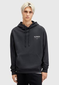 Felpa nera realizzata in tessuto morbido, con tasca frontale e cappuccio con cordino. Logo "ALLSAINTS" stampato sul petto in bianco.
