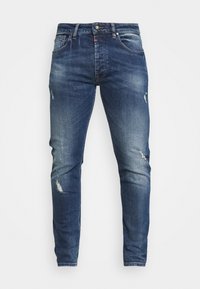 Slim-fit jeans i mörk denim med en blekt tvätt. Har slitna detaljer och fem fickor. Stängs med en metallknapp och dragkedja.
