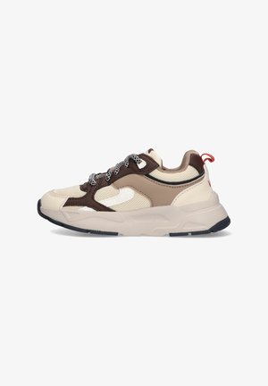 Beige and brown sneaker featuring mesh and synthetic materials, textured panels, chunky sole, and patterned laces with a red pull tab.