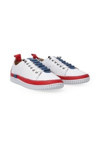 White sneakers with red and blue accents, featuring a textured sole, lace-up design, and colored eyelets. Red pull tab on the heel.