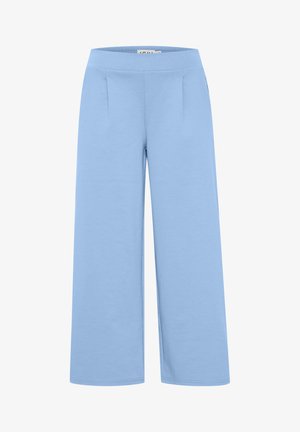 Heledad laiad sinised püksid, mis on valmistatud pehmest kangast. Neil on sile vöökoht ja kaks esi ploome, et lisada struktuuri.