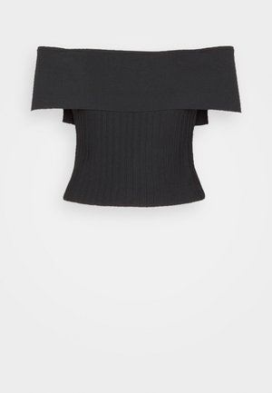Black off-the-shoulder top with ribbed texture paired with high-waisted, wide-leg gray trousers featuring pleats and side pockets.