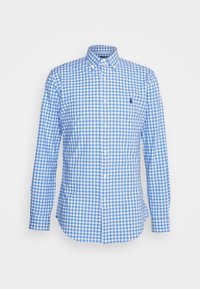Blå och vit rutmönstrad skjorta med lång ärm och knapp-öppen krage, med en liten logo på bröstet och rak nederkant.
