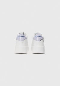 White sneakers with a smooth texture, featuring a purple accent on the heel and "KARL LAGERFELD" logo in blue. Chunky white sole.