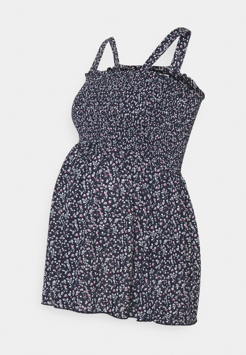 Robe de maternité florale en marine, avec un corsage smocké, des fines bretelles et une coupe décontractée. Motif floral avec des accents blancs et roses.