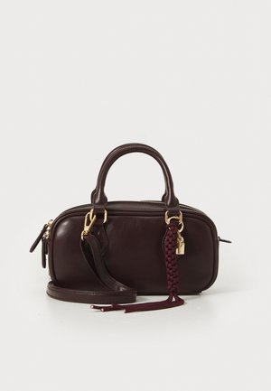 Dark brown leather handbag with a braided tassel, gold-tone hardware, double handles, and a detachable shoulder strap on a white background.