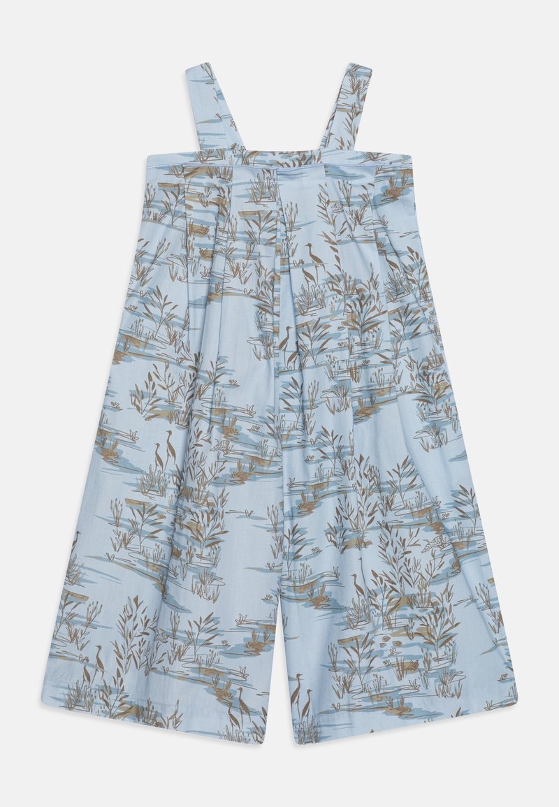 Combinaison sans manches bleu clair avec jambes larges et imprimé marron et gris sur le thème de la nature, représentant des plantes et des oiseaux.