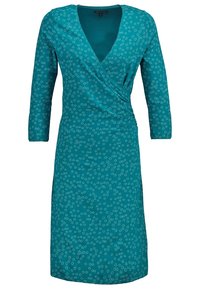 Turquoise wikkeljurk met lange mouwen, voorzien van een V-hals en een doorlopend textuur met bloemmotief. Soepele stof en een knielange snit.