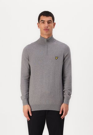 Pull à col zippé gris en tissu doux, avec un col et des poignets côtelés, doté d'un petit logo jaune sur la poitrine gauche.