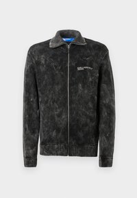 Fekete kordbársony dzseki bordázott textúrával, álló gallérral és elülső cipzárral; a mellkason a 'Karl Lagerfeld Jeans' logó található.