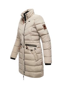 Beige padded winter coat with high collar, zippered pockets, contrasting black accents, and logo patch on the sleeve.